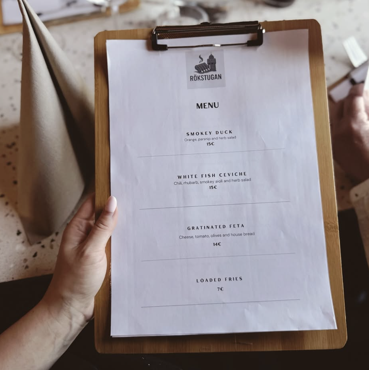 Rökstugan menu on a clipboard